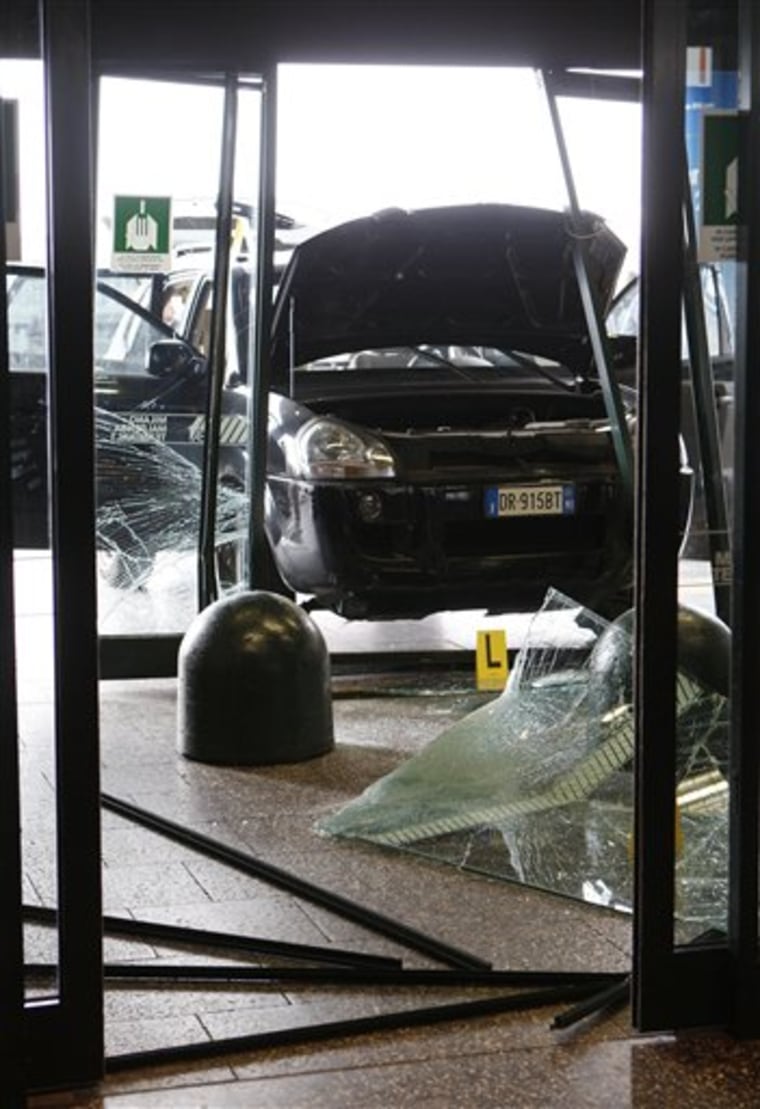 A car that crashed through a window into a departure terminal is seen Monday at Milan's Malpensa airport.